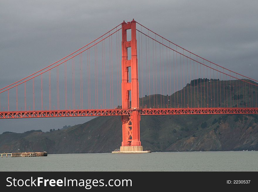 Golden Gate Bridge illuminated by sunlight on cloudy day, San Francisco