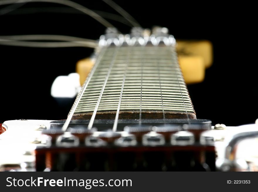 Close up at electric guitar fingerboard with focus set on highest frets. Close up at electric guitar fingerboard with focus set on highest frets