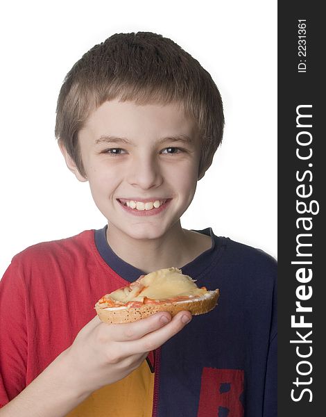 Smiling boy eating the sandwich on white backgro