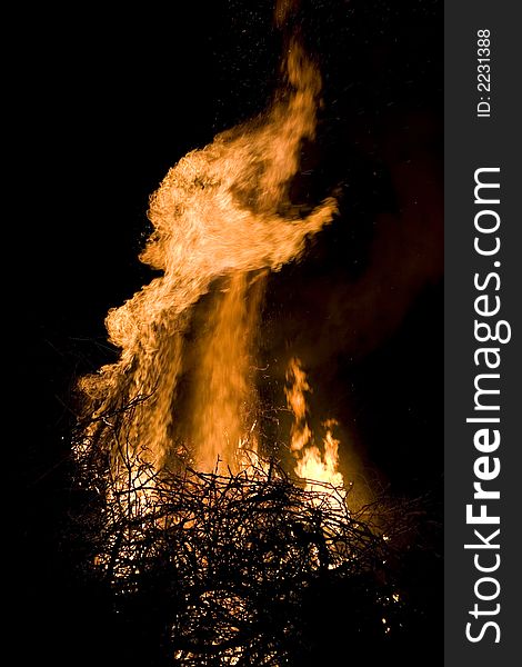 A photo of burning wood with detailed flames. A photo of burning wood with detailed flames