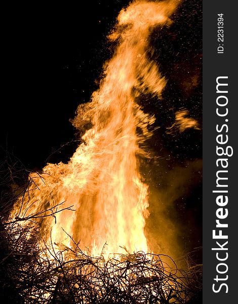 A photo of burning wood with detailed flames. A photo of burning wood with detailed flames