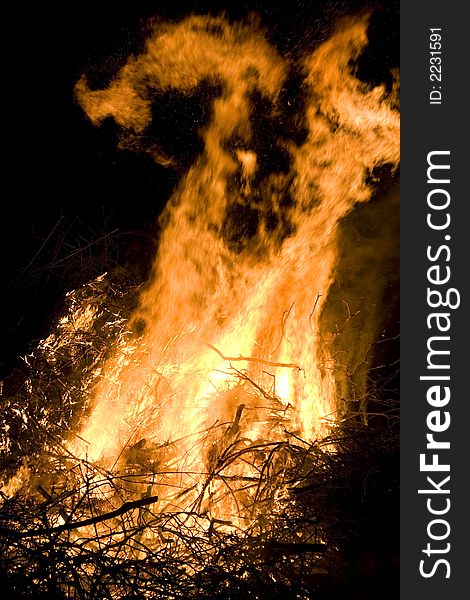 A photo of burning wood with detailed flames. A photo of burning wood with detailed flames