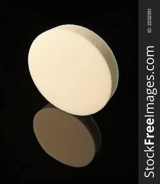 White make up sponge on black background