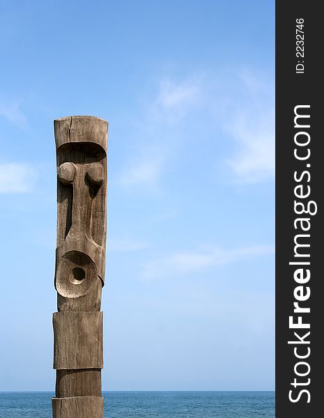 A wooden carved totem pole in france by the sea. A wooden carved totem pole in france by the sea