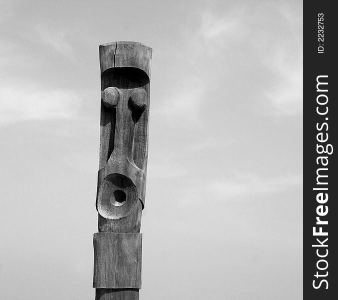 A wooden carved totem pole in france by the sea. A wooden carved totem pole in france by the sea