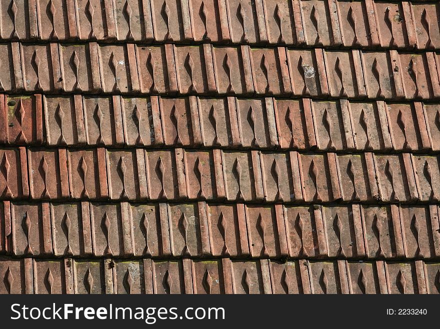 Detail of an old roof made with originally red tiles. Great texture. Detail of an old roof made with originally red tiles. Great texture.