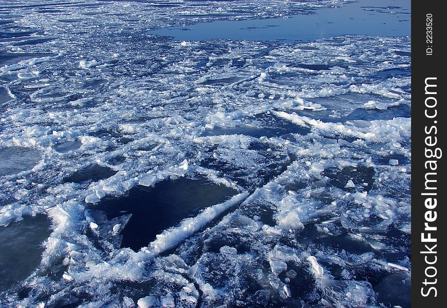 Ice melting in a river's water at spring time as a background. Ice melting in a river's water at spring time as a background.