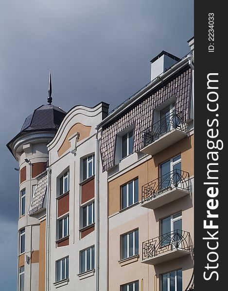 Modern classic building with balconies and tiled penthouse
