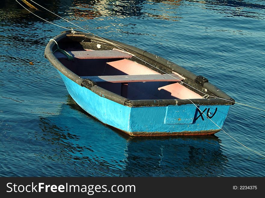 Beautiful small boat moored  in blue sea. Beautiful small boat moored  in blue sea