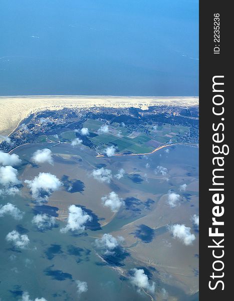 View onto clouds cruising over an island in the north sea. View onto clouds cruising over an island in the north sea