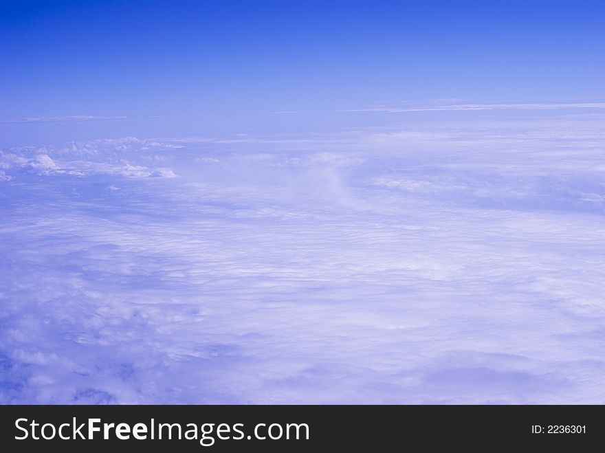 Light Clouds Background with clear horizon. Photo taken during flight travel