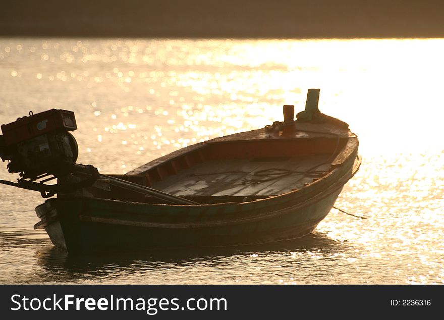Capturing a small boat at sunrise in the Andaman sea in Thailand. Capturing a small boat at sunrise in the Andaman sea in Thailand