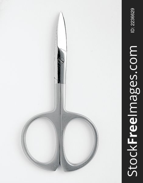 Close up of cosmetic scissor isolated on white background.