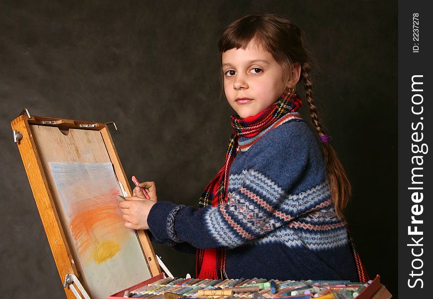 The girl draws paints in studio. The girl draws paints in studio