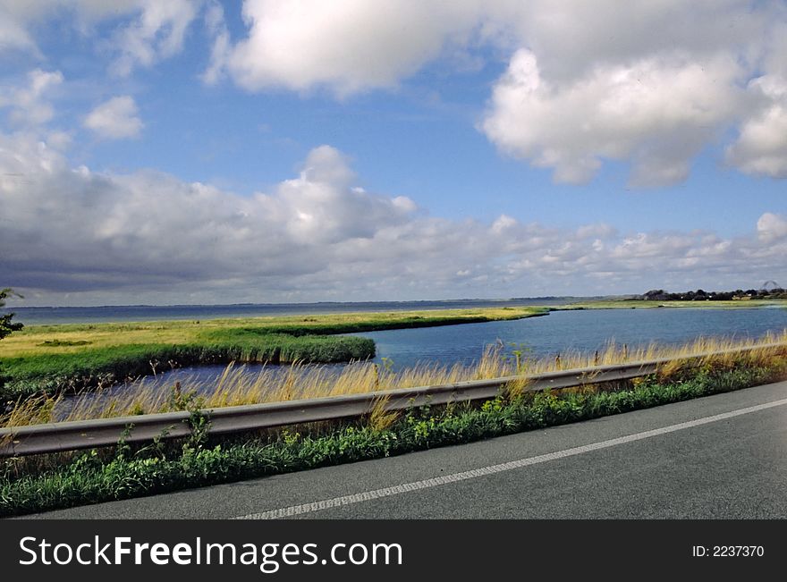 Road in the north of denmark with green field and blu sky. Road in the north of denmark with green field and blu sky