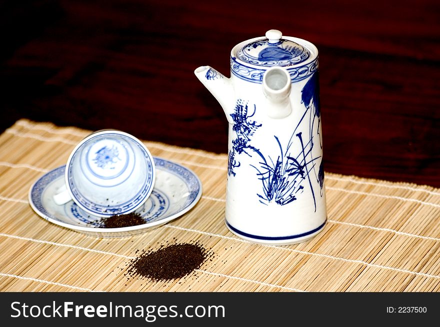 Chinease tea pot and chinease rice tea cup with tea leaves. Chinease tea pot and chinease rice tea cup with tea leaves