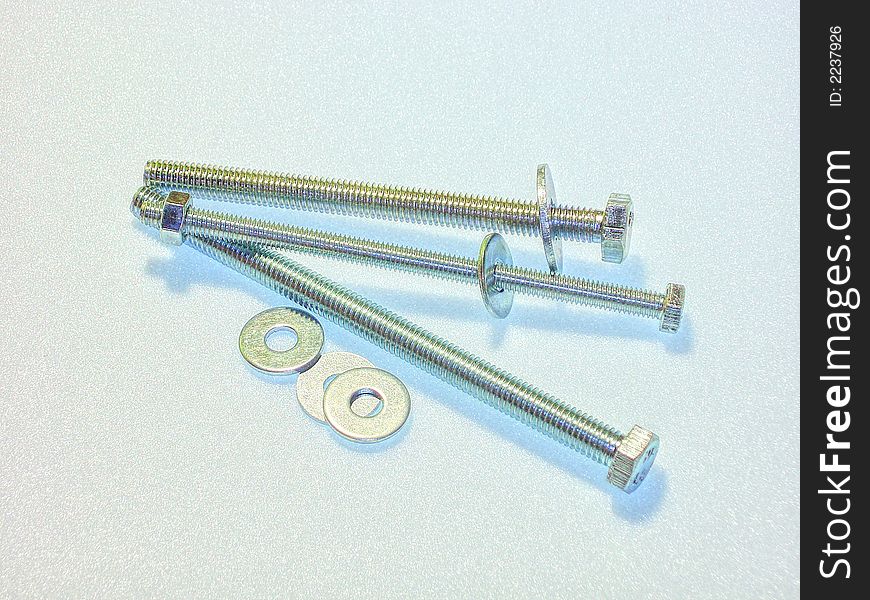 Three bolts laying on a white background