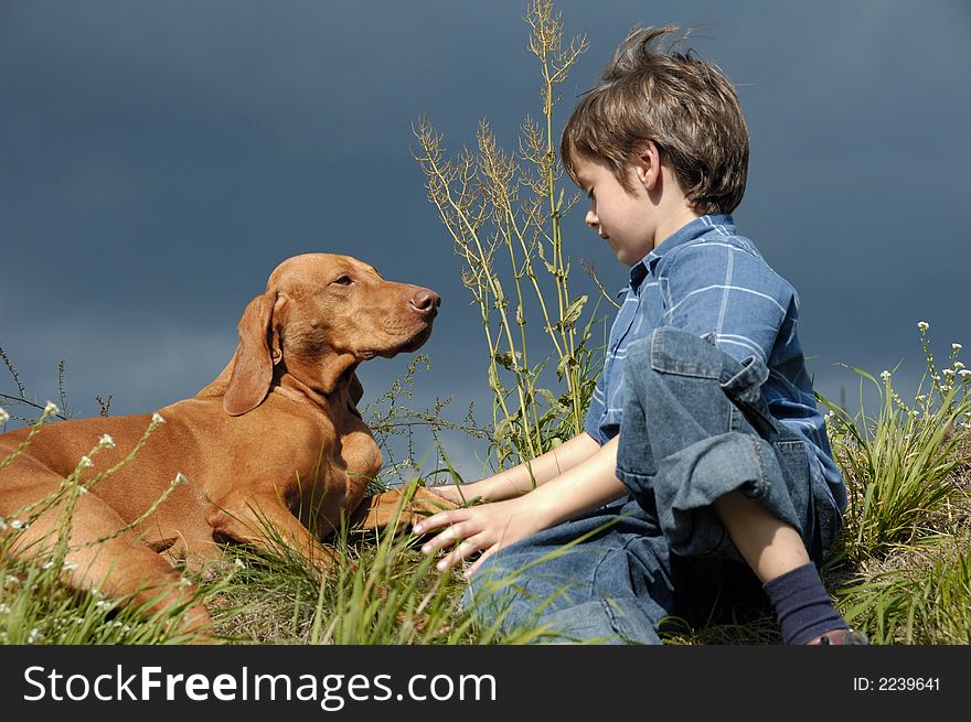 Young Boy Talking To His Dog