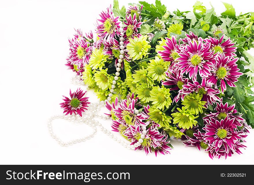 Bouquet of pink and green chrysanthemums with Pearl necklace on a white background. Bouquet of pink and green chrysanthemums with Pearl necklace on a white background