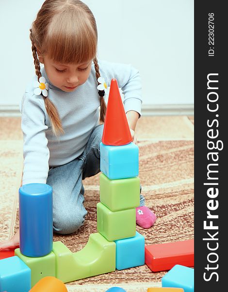 Little girl playing with cubes