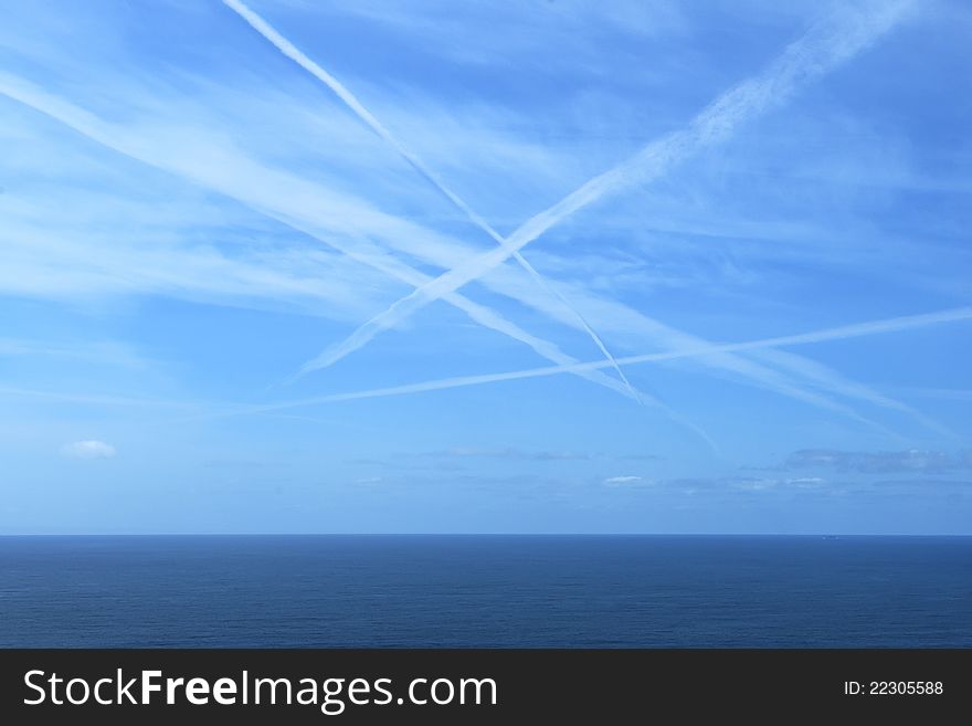 Plane marks on the sky over the sea