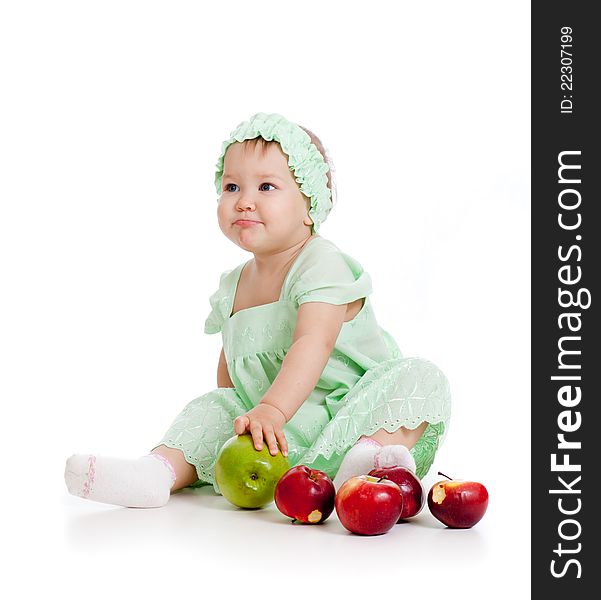 Baby girl with healthy food apples