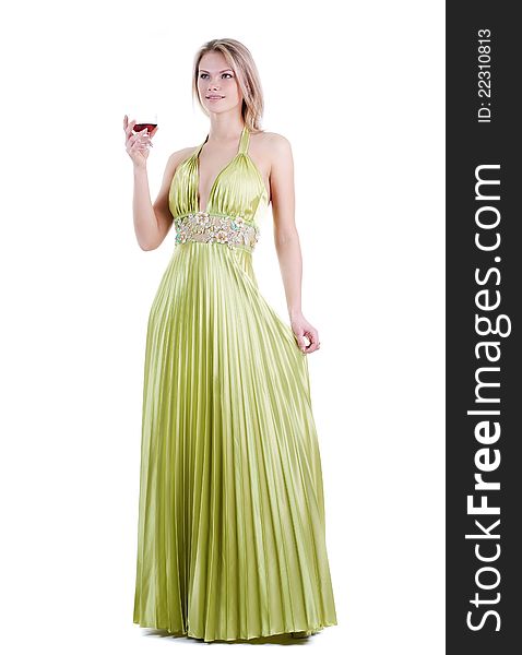 The girl in a long green dress costs with a glass isolation. The girl in a long green dress costs with a glass isolation