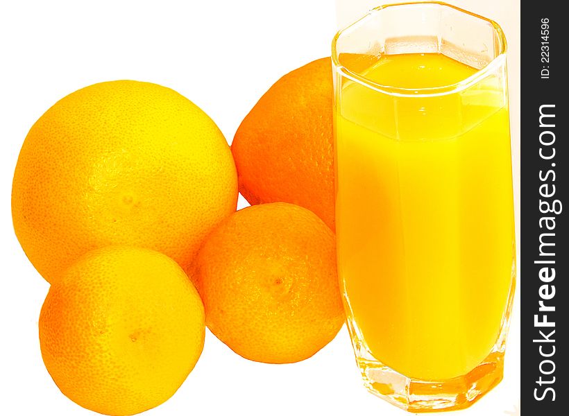 Juicy citrus fruits with glass of juice. Juicy citrus fruits with glass of juice