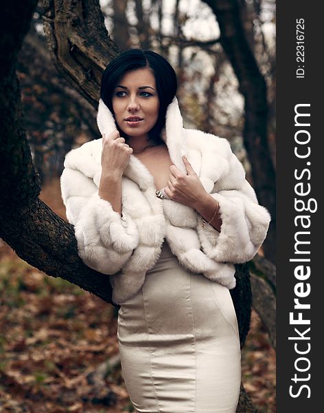 Elegant Girl In White Coat With High Collar