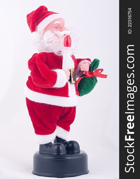 Santa Claus doll with red light and green bag.