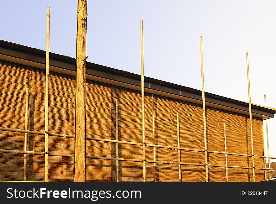 Simple scaffolding setup on a domestic property being rendered with plaster. Perspective corrected. Copy space. Simple scaffolding setup on a domestic property being rendered with plaster. Perspective corrected. Copy space.