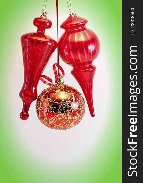 Red glass balls and cones on white with green vignette. Red glass balls and cones on white with green vignette.