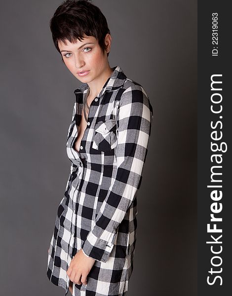 A portrait of a beautiful young model wearing a black and white collared shirt-dress. A portrait of a beautiful young model wearing a black and white collared shirt-dress