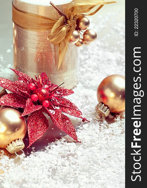 Christmas composition with decorations: candle, baubles and star, closeup shot, focus on the star