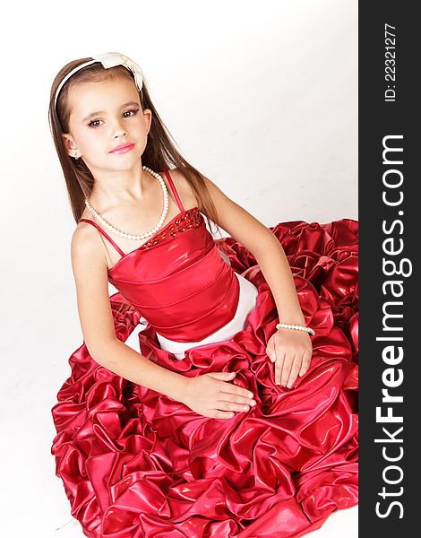 Beautiful little girl in red evening dress