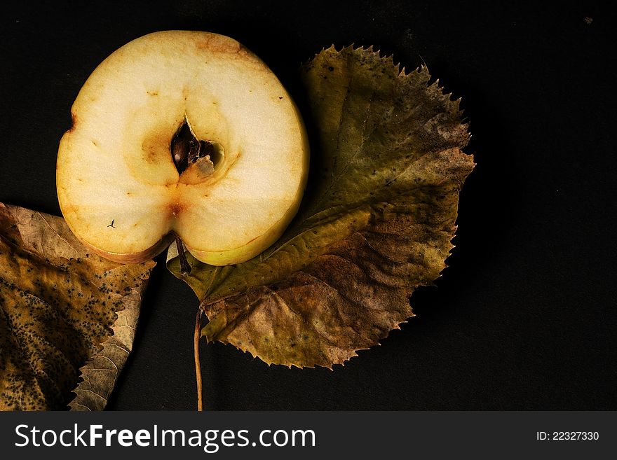 Closeup with sliced apple and leaves studio isolated on black background. Closeup with sliced apple and leaves studio isolated on black background