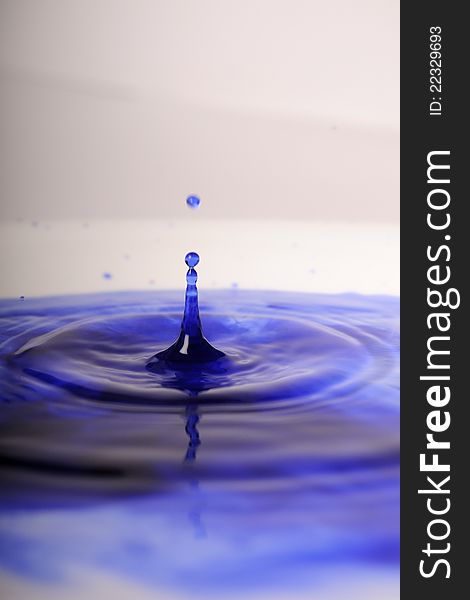 Closeup with blue ink drop in water. Closeup with blue ink drop in water