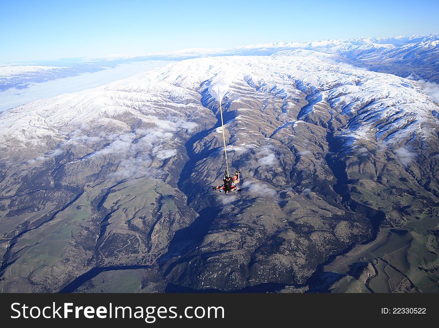 Skydive over snow mountain