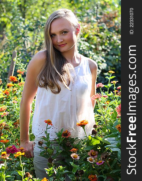 Beautiful young woman among the flowers