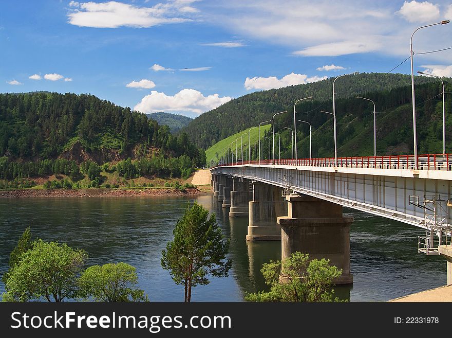 Bridge through mountain river Russia, Summer