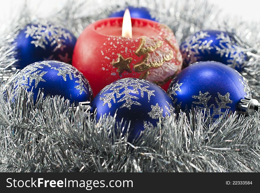 Christmas decoration of blue balls and a burning candle