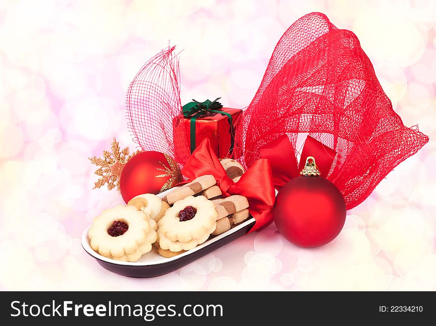 Beautiful christmas still life with biscuits, red xmas balls, gift and various decoration. Bokeh christmas food and decoration background. Beautiful christmas still life with biscuits, red xmas balls, gift and various decoration. Bokeh christmas food and decoration background.