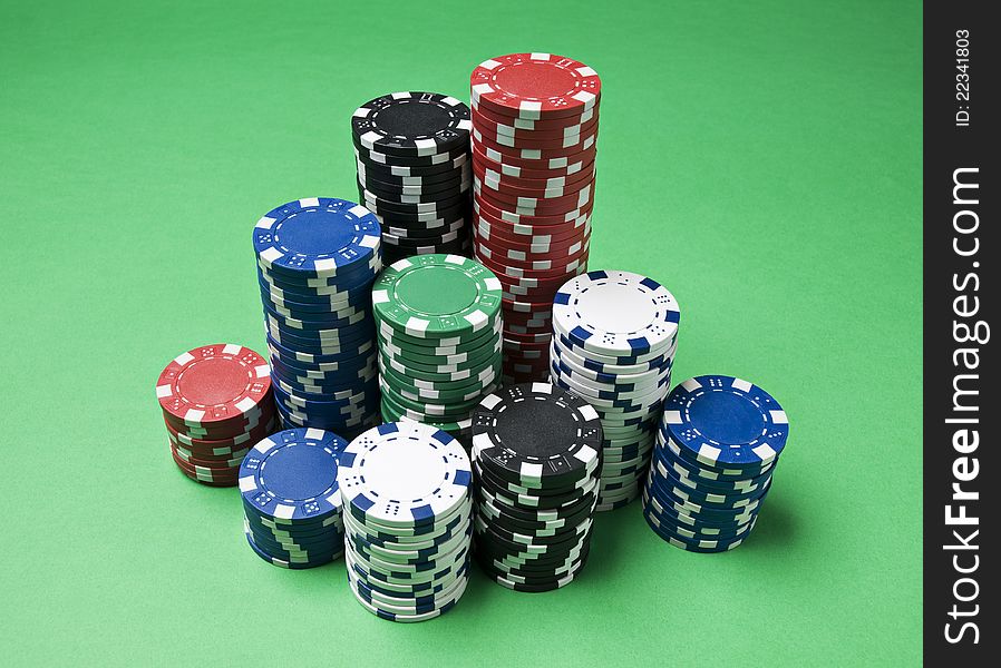 Gambling chips on green background close up