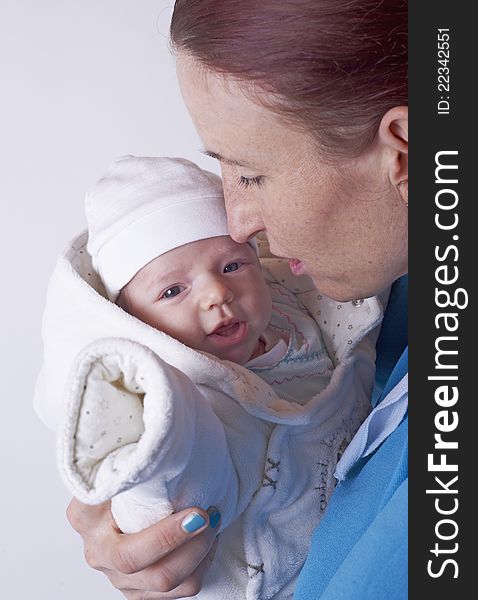 Middle aged women with her cute newborn female baby laughing with her eyes wide open, image taken as black and white with blur around the focus in the middle, less contrast. Middle aged women with her cute newborn female baby laughing with her eyes wide open, image taken as black and white with blur around the focus in the middle, less contrast