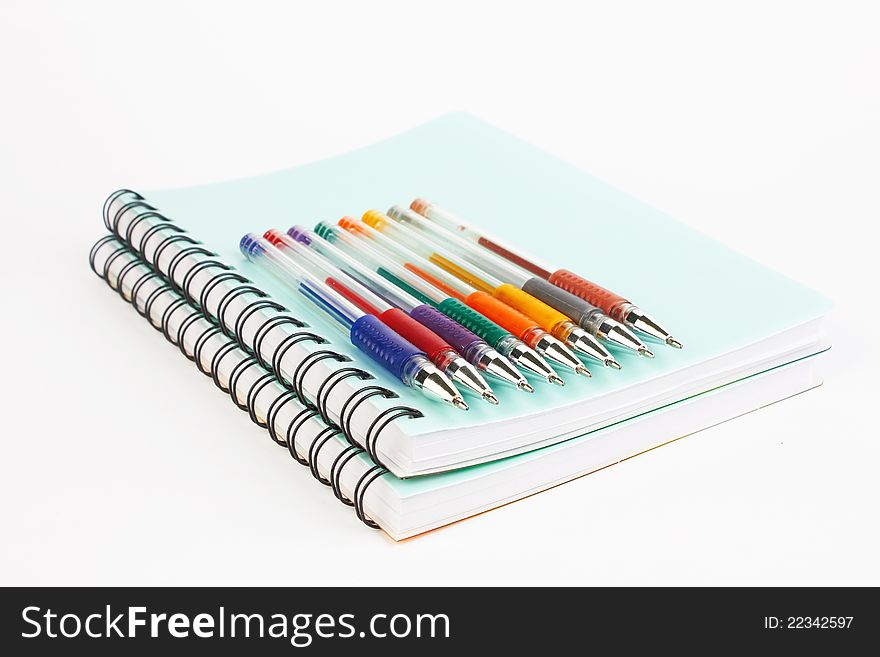 Notebooks and pens on a white background