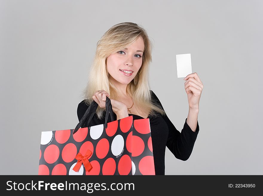 Young shopping girl confidence shows a blank plastic card. Young shopping girl confidence shows a blank plastic card