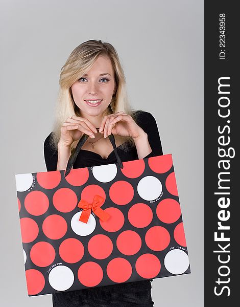 Young and beautiful girl holds a shopping bag. Young and beautiful girl holds a shopping bag