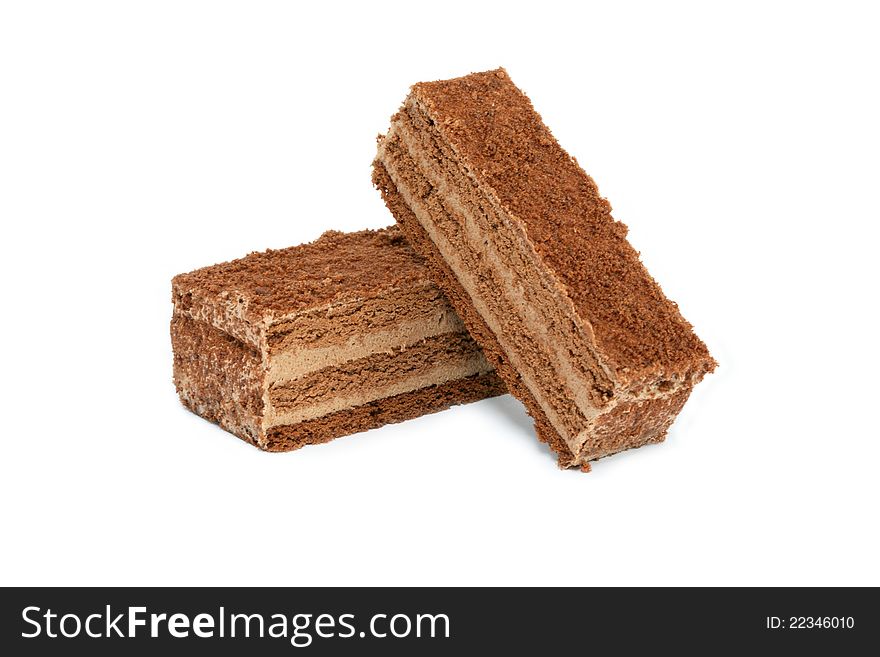 Two pieces of chocolate cake on white background