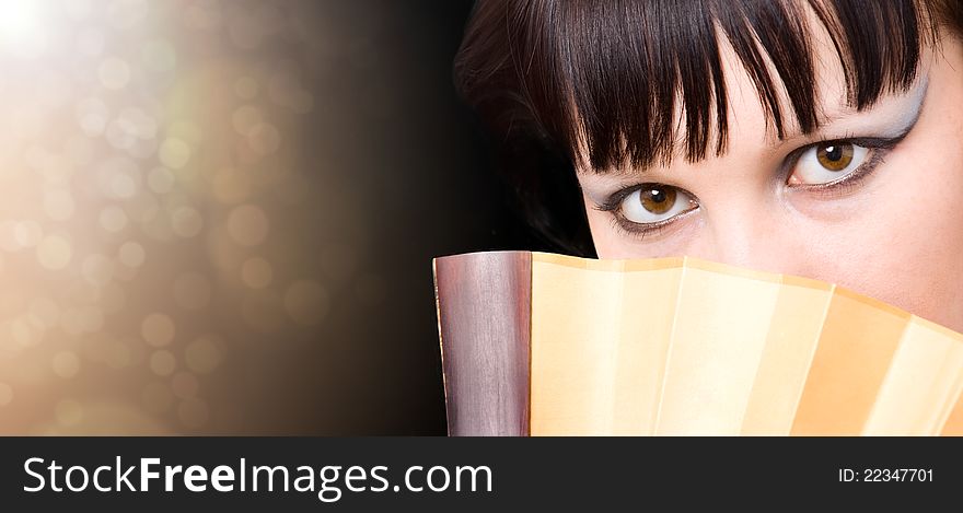 Portrait of the girl with a fan. Closeup. Portrait of the girl with a fan. Closeup