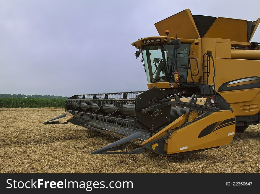 yellow combine /harvester / in the field. yellow combine /harvester / in the field